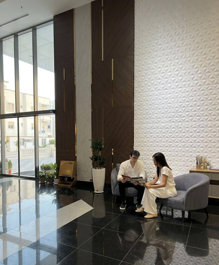 SilkNomads team reviewing tour itineraries with local partners in a boutique hotel lobby in Uzbekistan