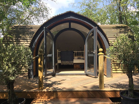 view of lodge with open french doors on sunny day
