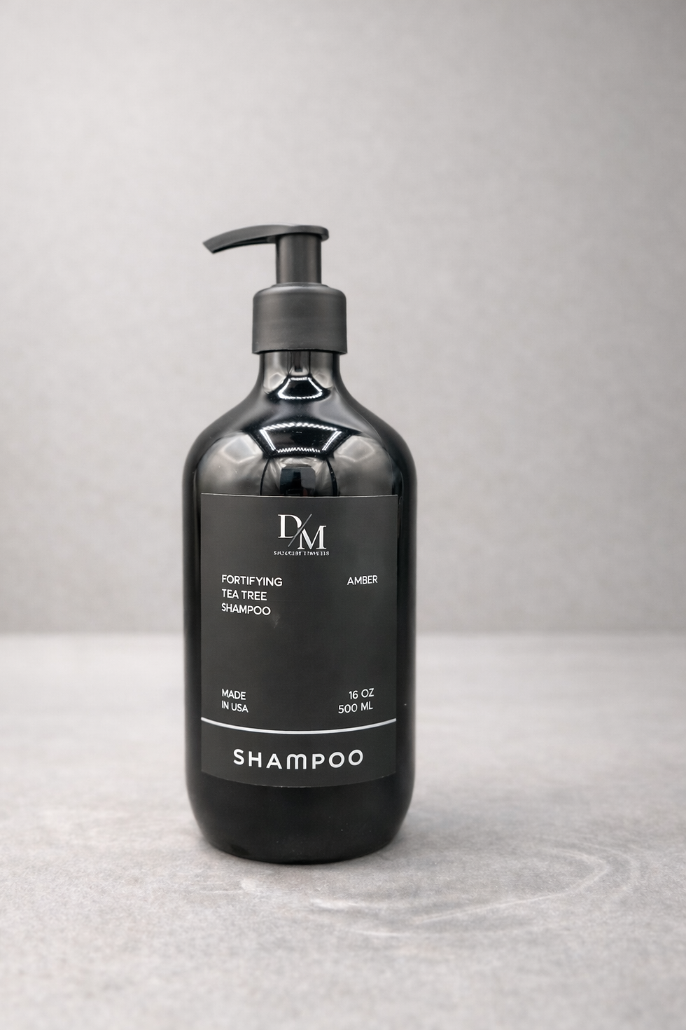 Luxury shampoo shown in black plastic 500ml bottle with black hand pump and black label