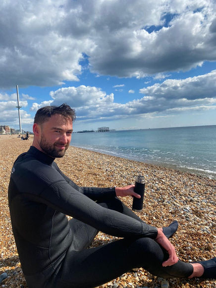 geophysicist in a wetsuit by sea