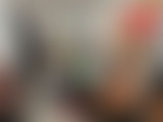 Group art class where guests enjoy wine while painting in a creative studio environment