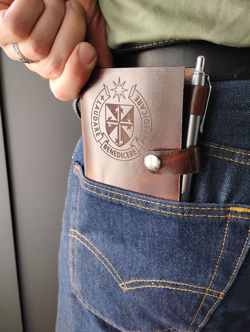 Brown leather custom journal cover in back jeans pocket.