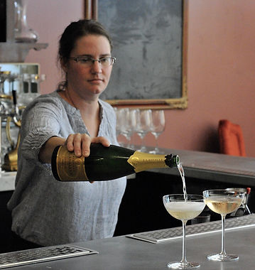 Courtney pours Champagne