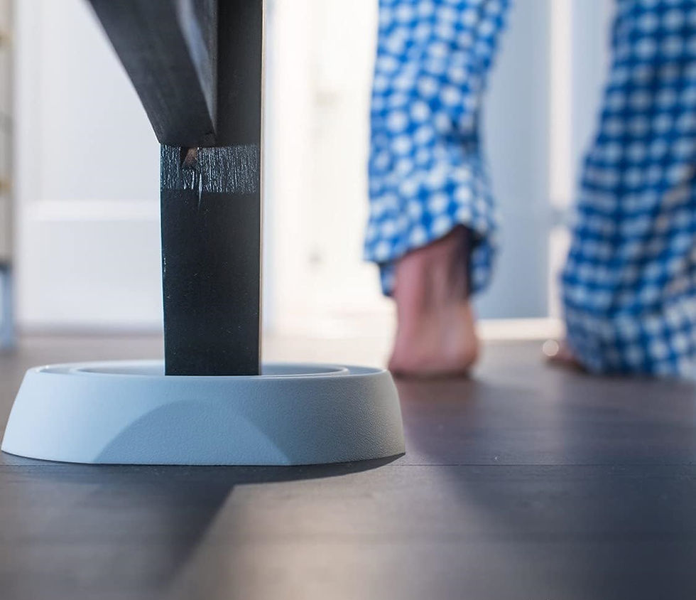 Thumbnail: White bed leg in round Bedbug Blocker, person in blue checked pajamas