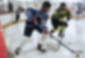 A man and a woman battle for a puck while playing ice hockey