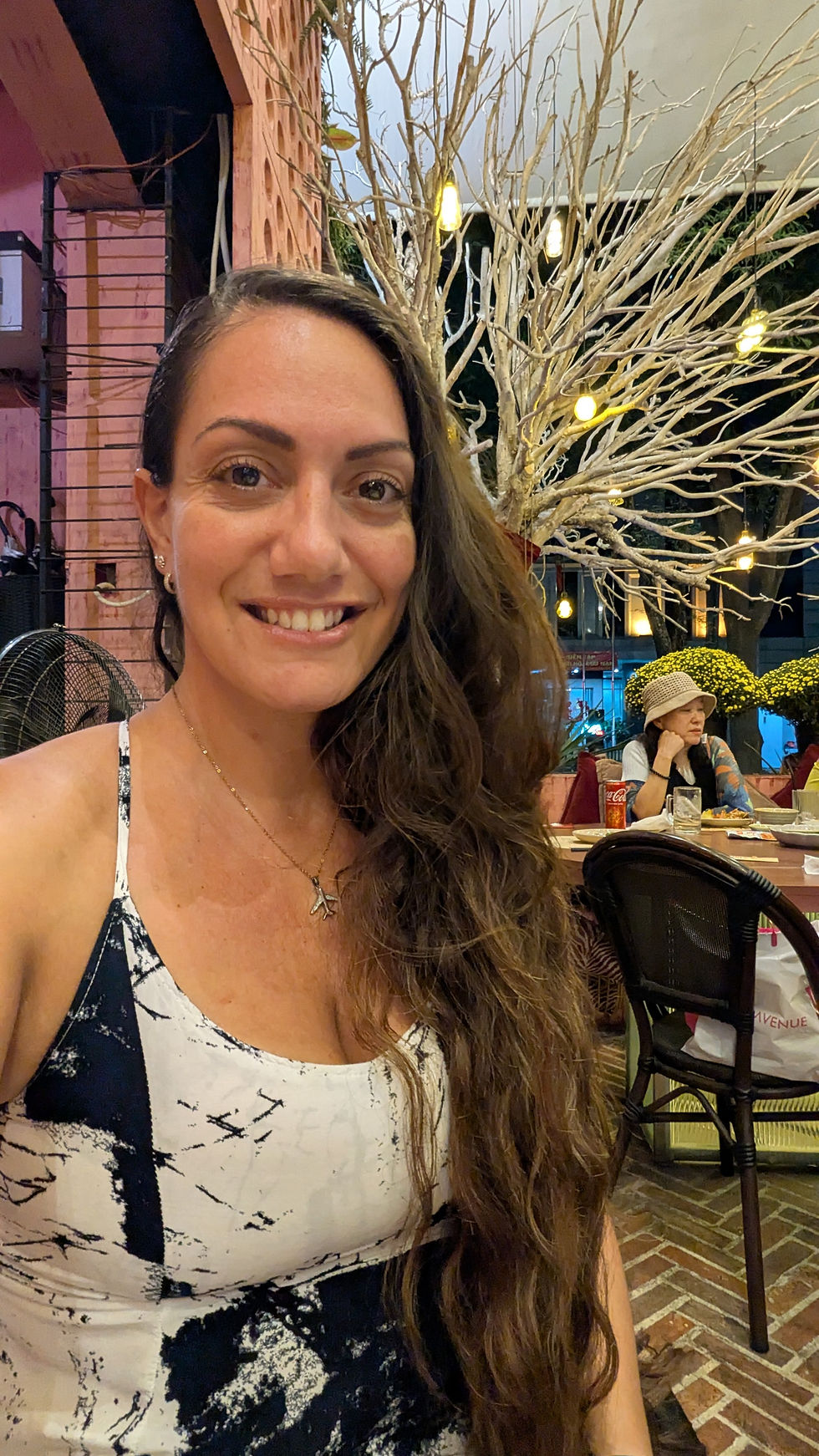 Maya at an outdoor restaurant at night in Saigon