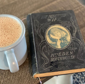 Fallon's bone broth hot chocolate and an antique book