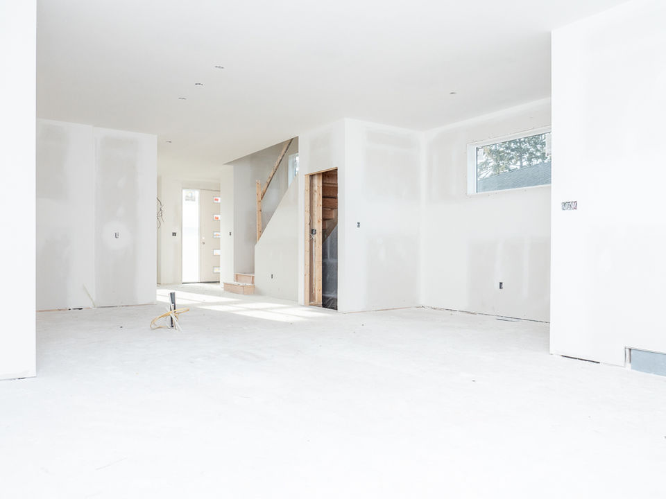 new drywall installation in open residential basement space Calgary smooth walls unfinished interior