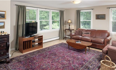 Living room before update with dated paint, older furniture, and odd layout