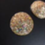 Close up of Gold Multi Glitter Circle Pasties on a Black Background