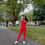 Thumbnail: Model outside wearing One Shoulder Textured Jumpsuit in Riot Red