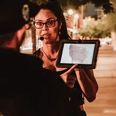 guest using ghost hunting equipment in downtown Phoenix during a ghost tour at night