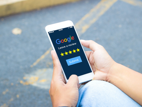 hands holding a mobile phone showing a screen to leave a Google review