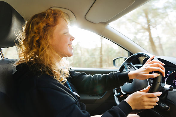 smiling-redhead-woman-driving-car.jpg