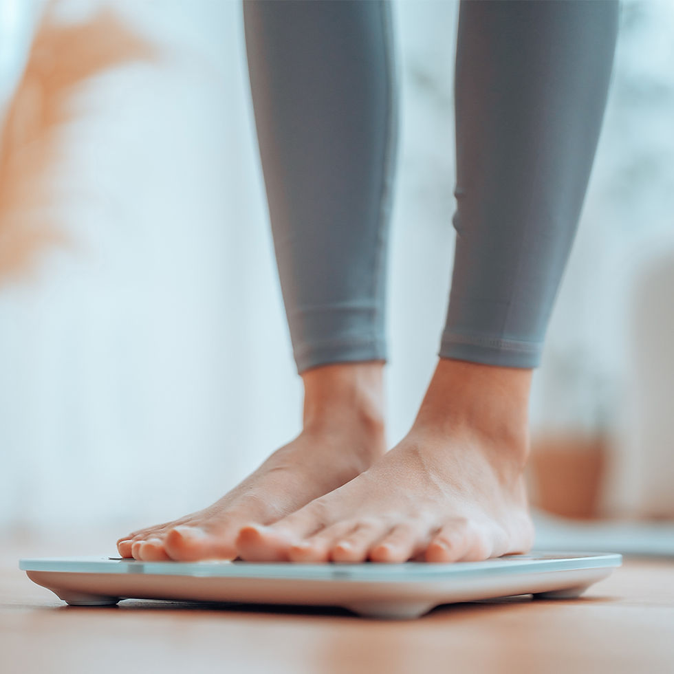 Closeup of feet, Young Asian woman standing on scales to measure her weight at home
