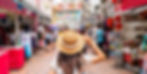 Young female tourist walking in Chinatown street market in Singapore