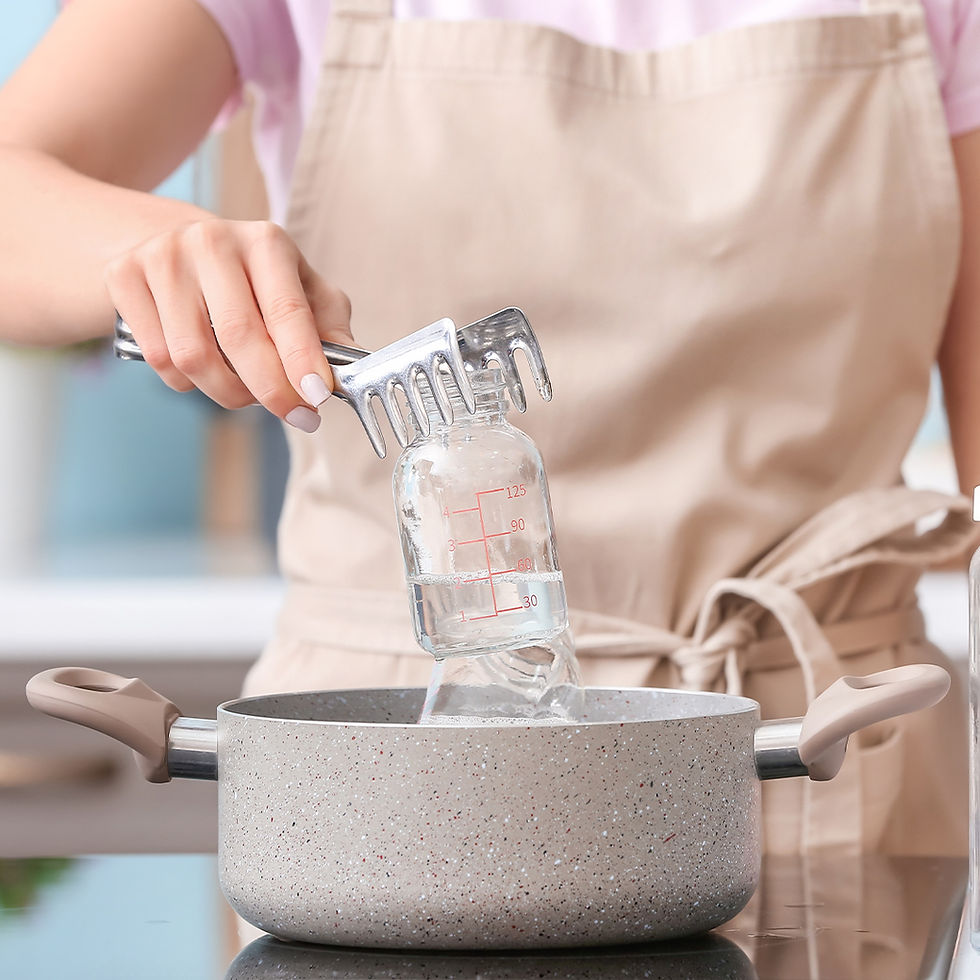 Woman cleaning baby bottle at home