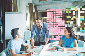 Three team members in a meeting room