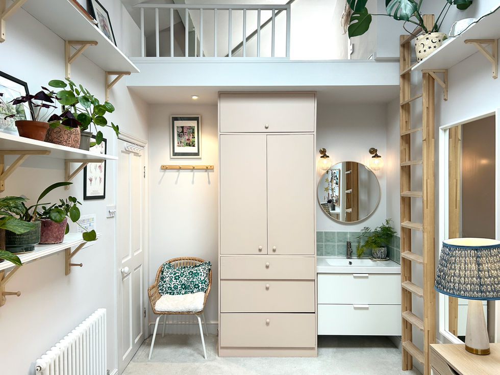 a bathroom with a wicker chair and a round mirror