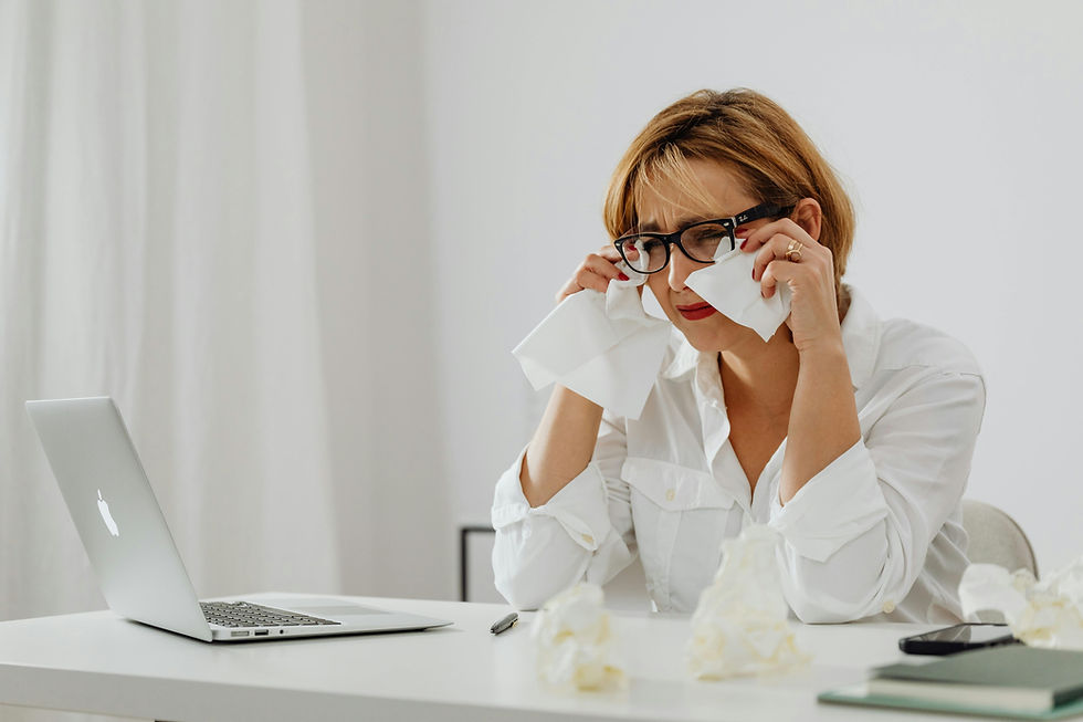 A frustrated US CPA firm owner reviewing financial documents late at night, representing the cost of onshore rework from cheap offshore bookkeeping.