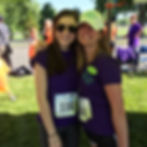 Emma Rothman and friend smiling at the camera wearing 5K tags