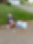 Young child sitting next to 'Mile 1' sign at the 5K