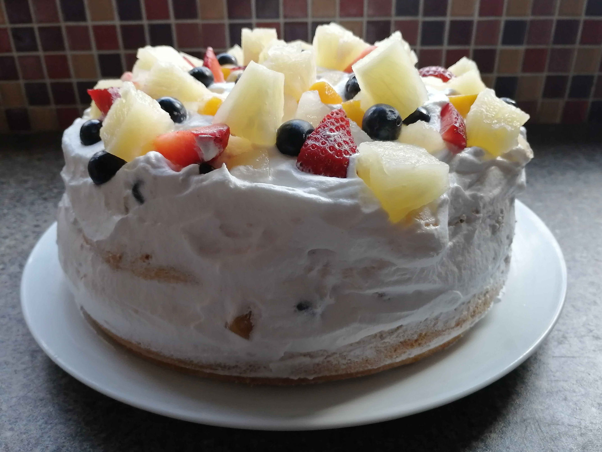 mixed fruit cream cake with covered sides