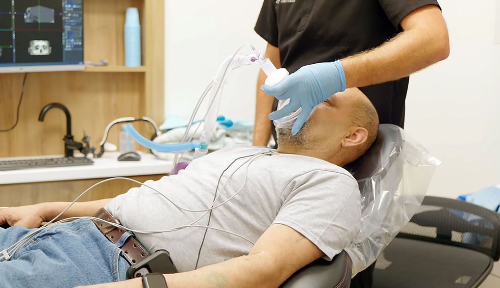 Anesthesiologist sedating a patient before dental implant treatment.