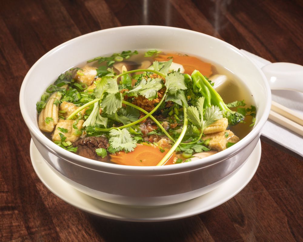 Clam soup in a black bowl