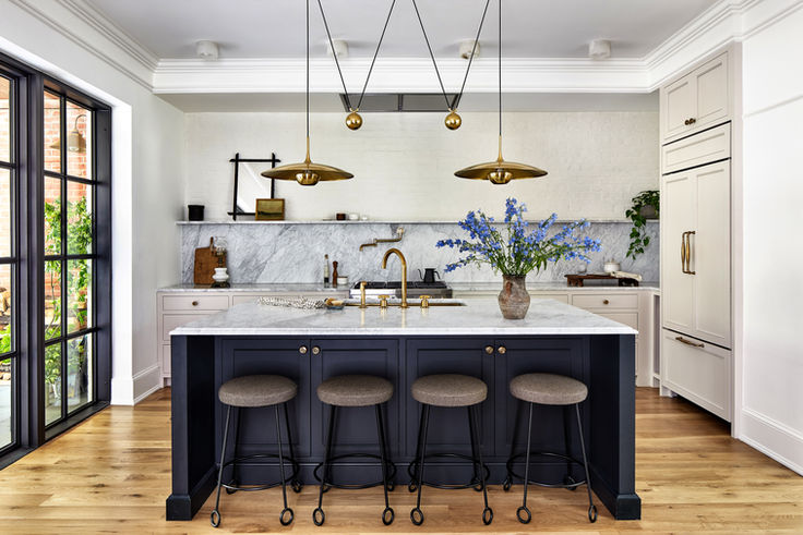 Kitchen designed with an island with dark blue accents