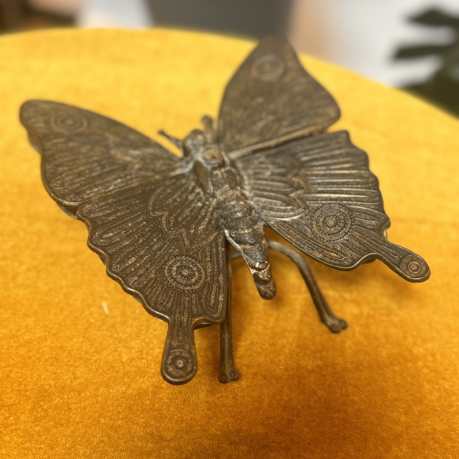 Iron butterfly with a compartment that folds up to reveal a hiding place