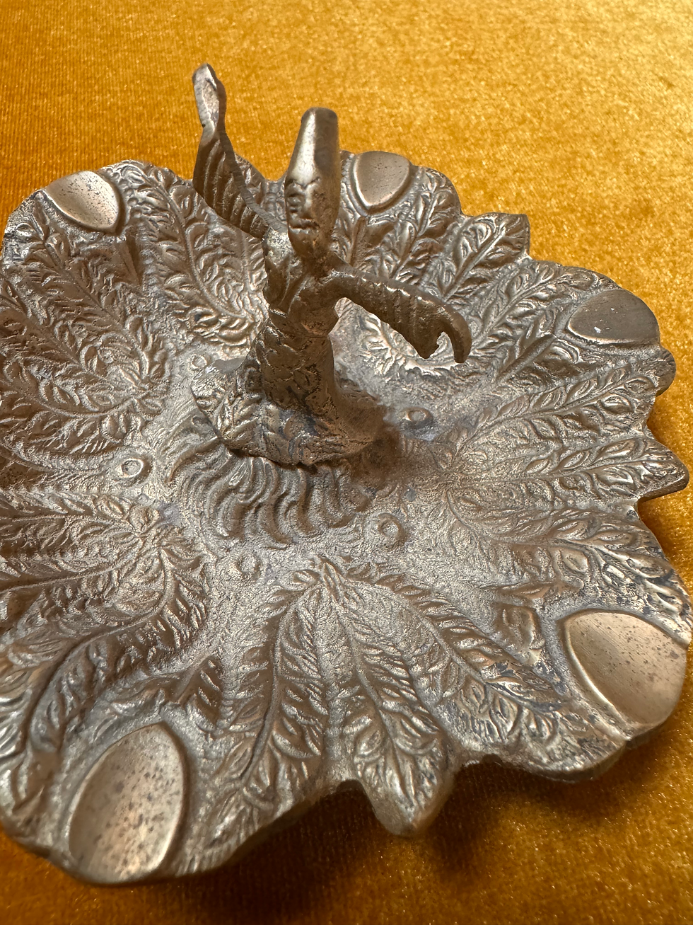 Silver bowl with wizard perched on top