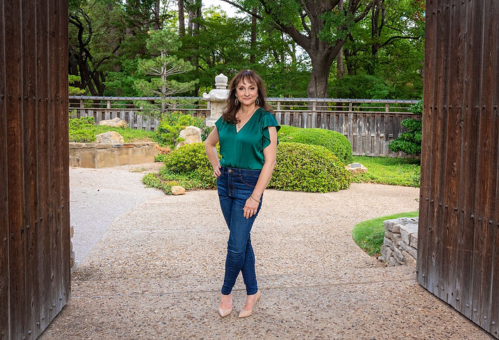Confident woman standing in garden