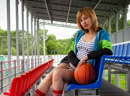 Smiling female trainer in workout gear preparing for in-home session