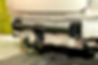 Close-up on a new black tow hitch installed on a modern car with a beige-colored bumper re