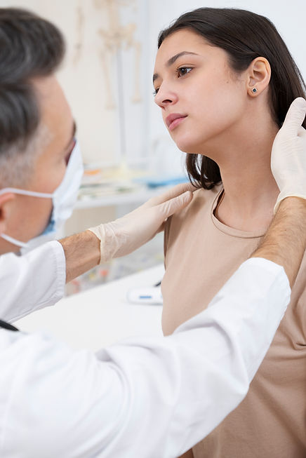 Doctor performing a routine medical checkup, examining a patient in a clinical setting.