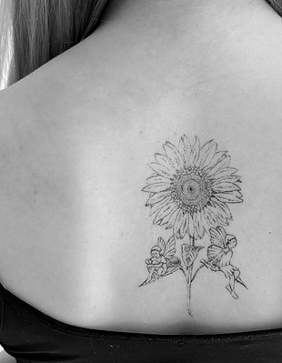 sunflower tattoo with pixies on a girls back