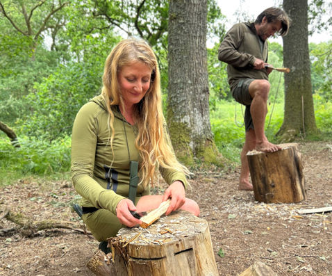 carving. spoon on a bushcraft course in the woods