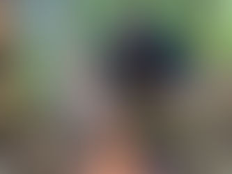 girl cooking a fish over a campfire on a bushcraft course in scotland