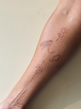 handpoked fineline symbol chain on womens forearm