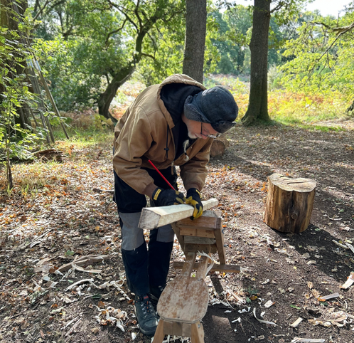 a man woodworking in the woods