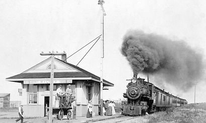 A vintage image of a coal train pulling into the old train station in Wilsey, Kansas