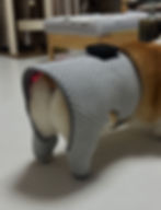 Close view of a gray perforated pet light wrap with illuminated red light.