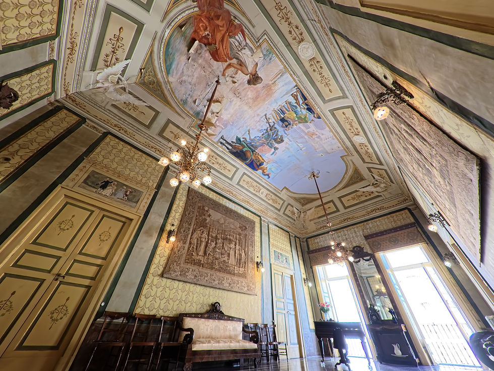 Frescoed ceiling, chandeliers and tapestries in the Palazzo reception salon