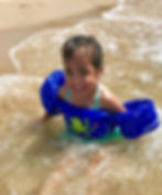 Smiling Girl Swimming at Beach