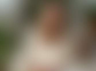 Midlife woman reflecting quietly by a sunlit window, symbolizing ADHD masking and emotional fatigue.