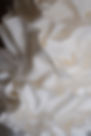 Extreme close-up of hand-sculpted white ruffles on a contemporary wedding cake by Copper Rose, Scotland.