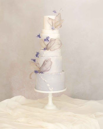Four-tier soft lilac ombré wedding cake with wafer paper flowers and rice paper sails by Copper Rose, for an editorial shoot at Chatelherault, Scotland.