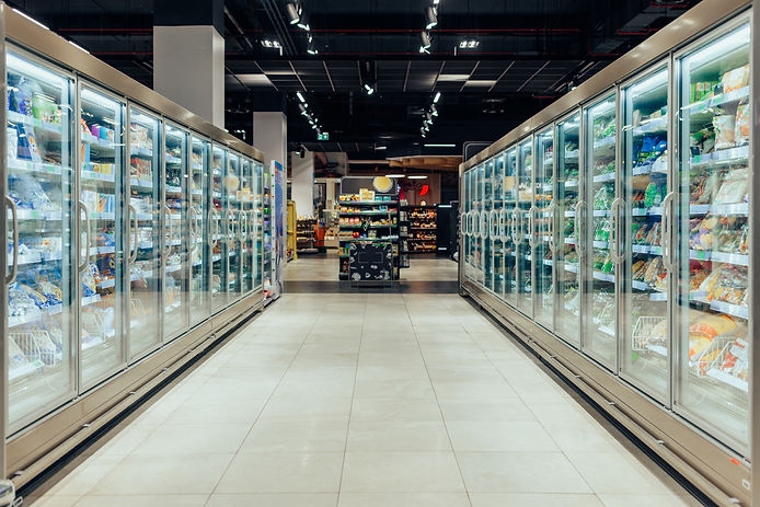 Empty supermarket aisle with freezers showcases with different products.jpg