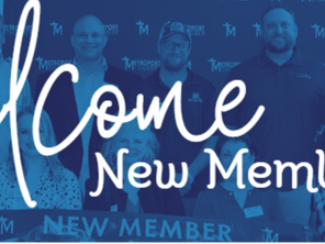 Photo of new chamber members with "Welcome New Members" sign.